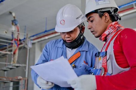 Construction - Two Man Holding White Paper