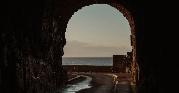 Leading Sustainability - Dark Tunnel Leading Towards Shore